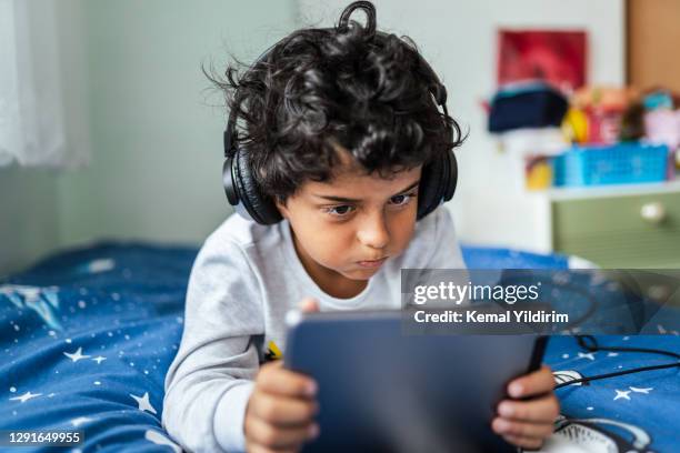 little boy bored taking online courses at home because of lockdown - watching youtube stock pictures, royalty-free photos & images