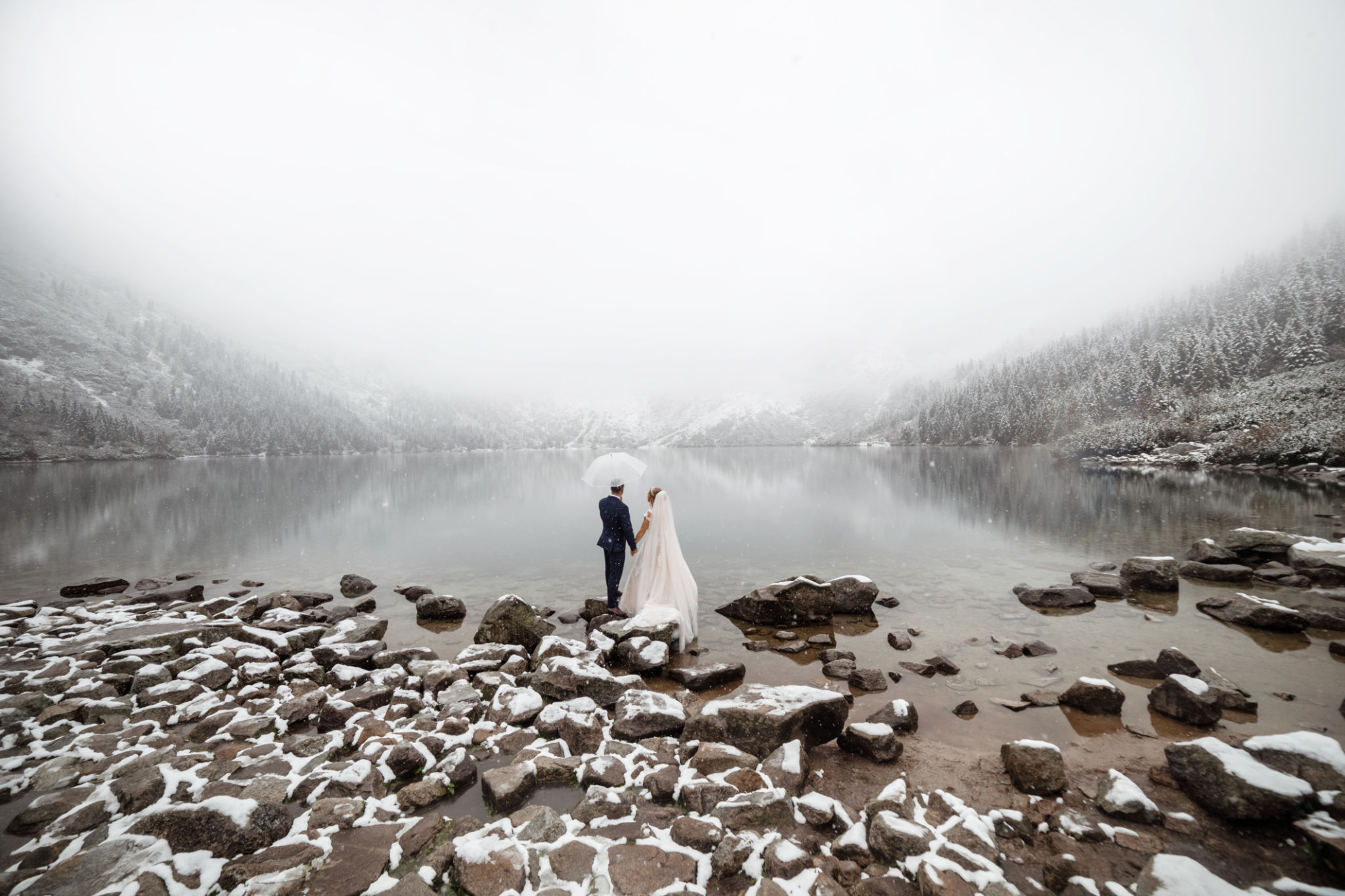 brides mountain near the lake in winter. Tender couple in love. brides mountain near the lake in winter. Tender couple in love.