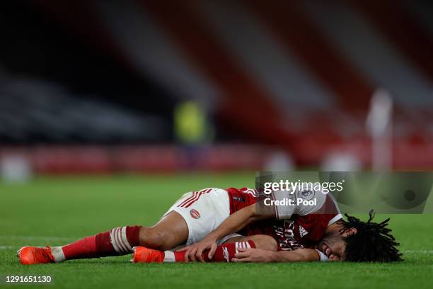 Mohamed Elneny of Arsenal goes down injured during the Premier League match between Arsenal and Southampton at Emirates Stadium on December 16, 2020...