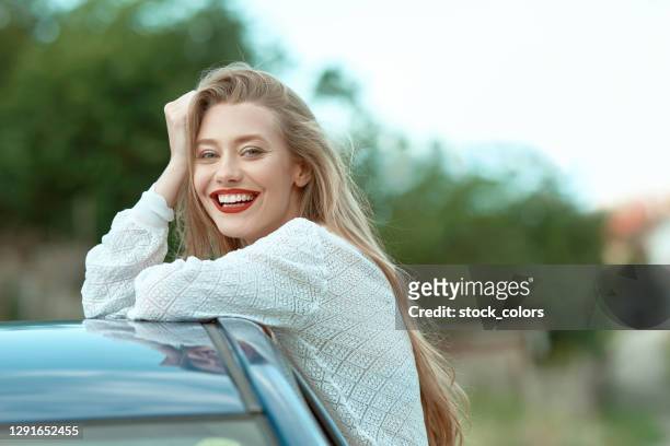 happy girl sitting on the edge of window car - beautiful romanian women stock pictures, royalty-free photos & images