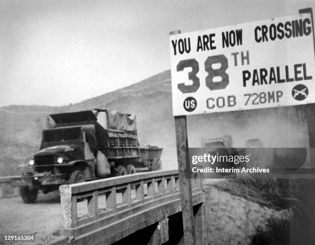 View of United Nations forces, traveling in trucks, crossing the 38th parallel as they withdraw from Pyongyang, the North Korean capital, 1950.