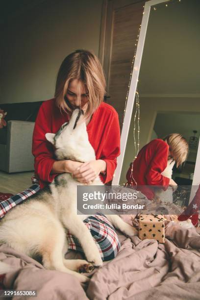 portrait of woman with dog - dog licking face stock-fotos und bilder