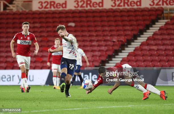 James Collins of Luton Town shoots as Sam Morsy of Middlesbrough gets a hand to the ball leading to a penalty and a red card during the Sky Bet...
