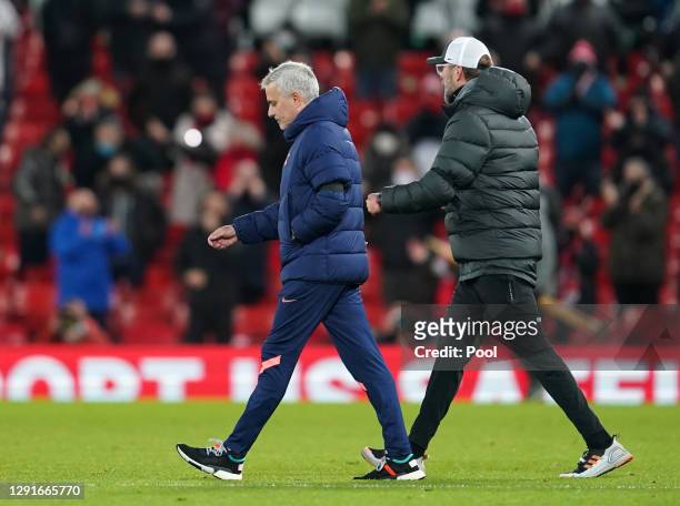 Jurgen Klopp, Manager of Liverpool celebrates as Jose Mourinho, Manager of Tottenham Hotspur looks dejected at full-time after the Premier League...
