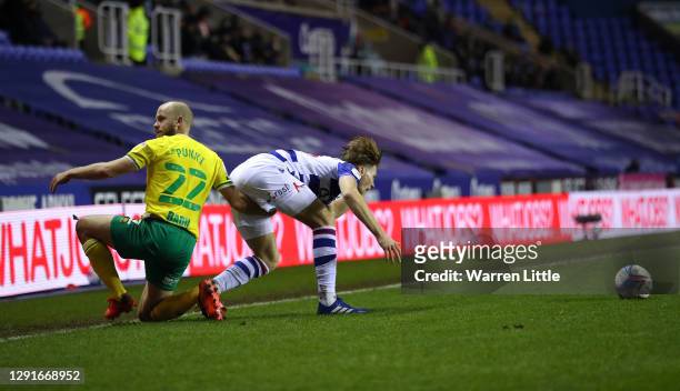 Lewis Gibson of Reading FC and Teemu Pukki of Norwich City clash during the Sky Bet Championship match between Reading and Norwich City at Madejski...