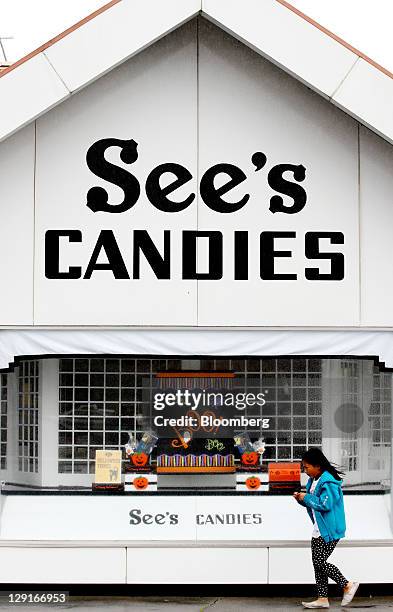Child walks past a See's Candies Inc. Retail shop next to the company's factory in San Francisco, California, U.S., on Monday, Oct. 10, 2011. See's...