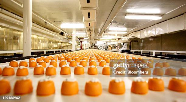 See's Candies Inc. Pumpkin candies travel down a conveyor belt before being boxed at the company's factory in San Francisco, California, U.S., on...