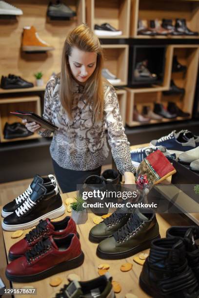 owner of online shoe business using digital tablet - shoe shop assistant stock pictures, royalty-free photos & images