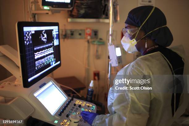 Regina Worthy performs an echocardiogram on a COVID-19 patient in the intensive care unit at Roseland Community Hospital on December 16, 2020 in...