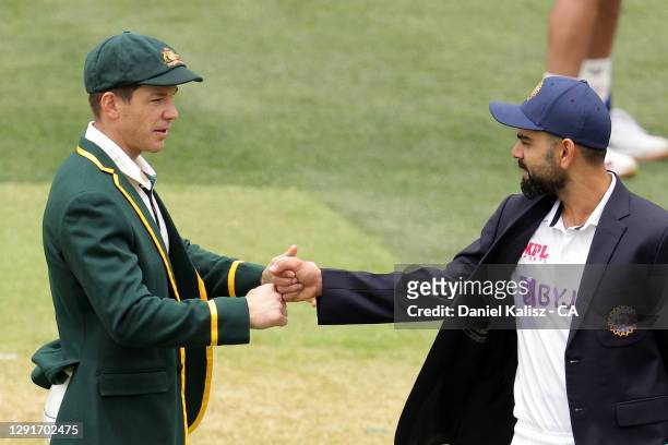 Tim Paine of Australia and Virat Kohli of India are pictured during the coin toss during day one of the First Test match between Australia and India...