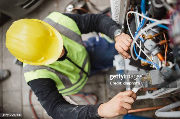 air conditioner technician services outdoor ac unit and the gas generator - industrial air compressor imagens e fotografias de stock