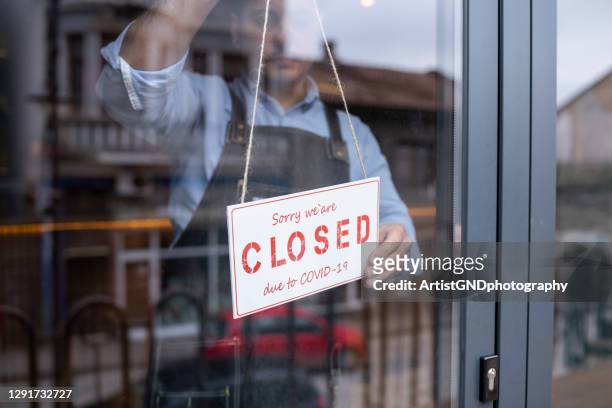 man closing his small business during covid-19 pandemic. - lockdown stock pictures, royalty-free photos & images