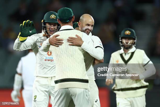 Nathan Lyon of Australia celebrates with Josh Hazlewood of Australia after the run-out of Virat Kohli of India during day one of the First Test match...