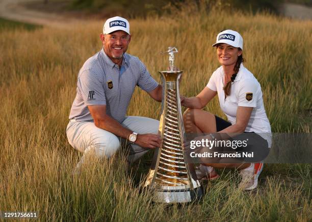 Lee Westwood of England and his caddie and girlfriend Helen Storey celebrate with the Race to Dubai Trophy following Day Four of the DP World Tour...