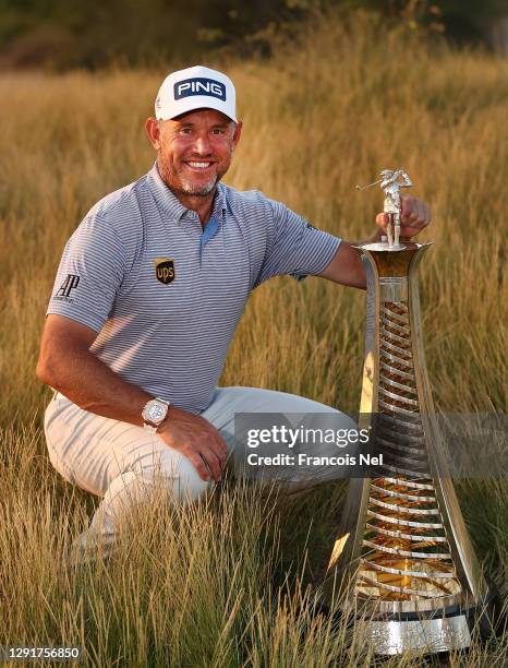 Lee Westwood of England celebrates with the Race to Dubai Trophy following Day Four of the DP World Tour Championship at Jumeirah Golf Estates on...