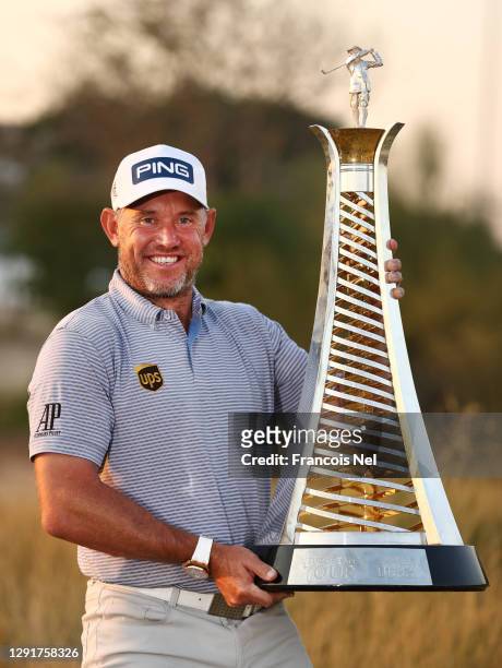 Lee Westwood of England celebrates with the Race to Dubai Trophy following Day Four of the DP World Tour Championship at Jumeirah Golf Estates on...