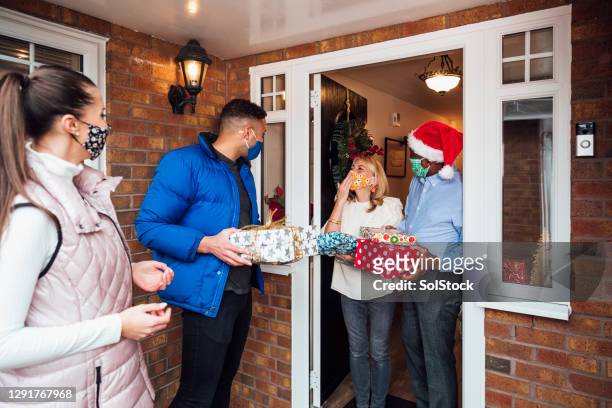 christmas present drop off - four people stock pictures, royalty-free photos & images