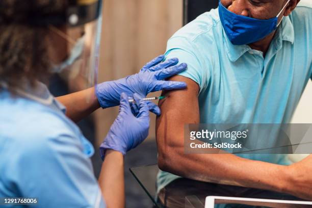 administering covid-19 vaccine - covid 19 vaccine stock pictures, royalty-free photos & images