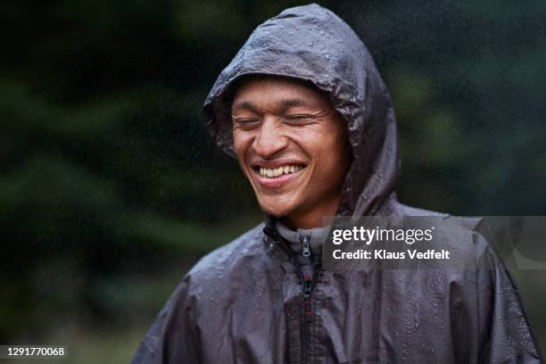 man getting wet in rain - rain coat stock pictures, royalty-free photos & images