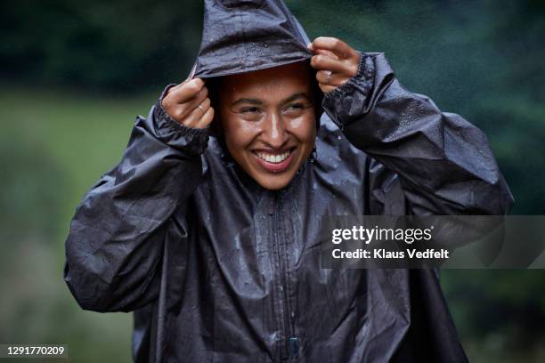 woman with raincoat in rainy season - レインコート ストックフォトと画像