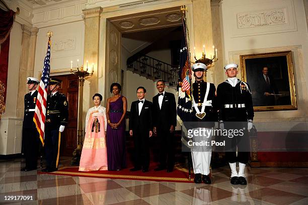 President Barack Obama and first lady Michelle Obama stand with South Korean President Lee Myung-bak and Lee's wife Kim Yoon-ok in the Cross Hall as...
