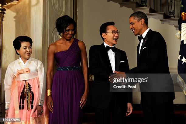 President Barack Obama and first lady Michelle Obama stand with South Korean President Lee Myung-bak and Lee's wife Kim Yoon-ok in the Cross Hall as...