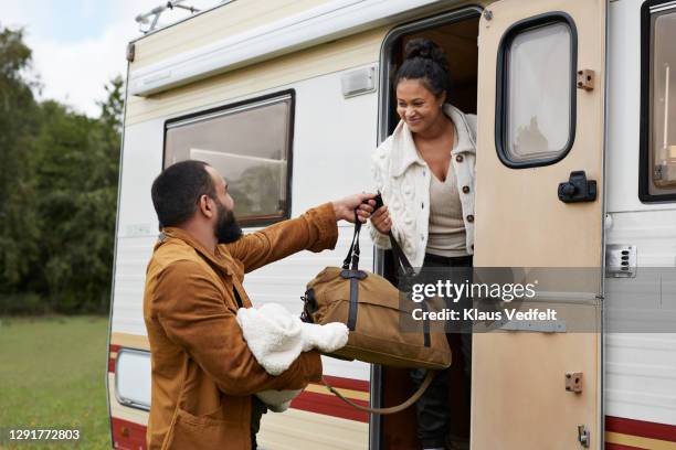 smiling parents with daughter holding bag in motor home - diaper bag stock pictures, royalty-free photos & images