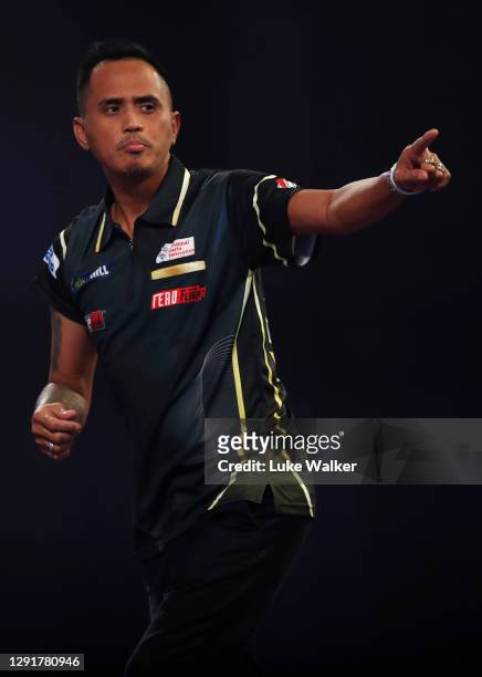 Lourence Ilagan of the Philippines reacts during his round one match against Ryan Murray of Scotland during the PDC William Hill World Darts...