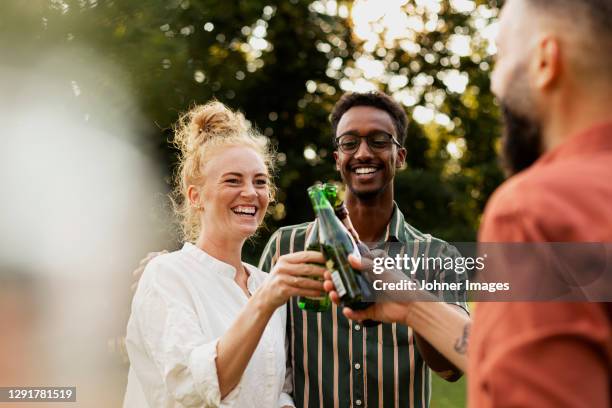 happy friends having beer in garden - rubbing alcohol stock-fotos und bilder