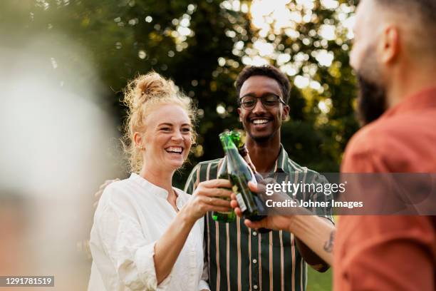 happy friends having beer in garden - isopropyl alcohol stock pictures, royalty-free photos & images