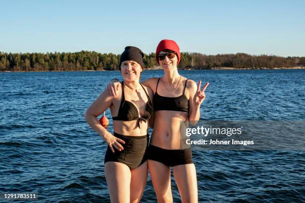 smiling women at lake - bathing stock pictures, royalty-free photos & images