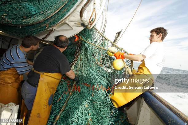 Fishermen inspect the trawl net aboard the Boulogne-sur-Mer based trawler "La Fregate" during a 2 days fishing campaign in North Sea off the coast of...