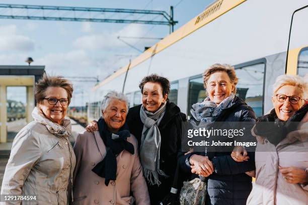 women on train station platform - senior public transportation stock pictures, royalty-free photos & images