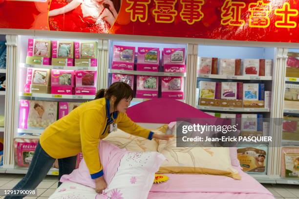 Vendeuse au rayon literie dans l'hypermarché Carrefour, 27 février 2007, Shangai, Chine.