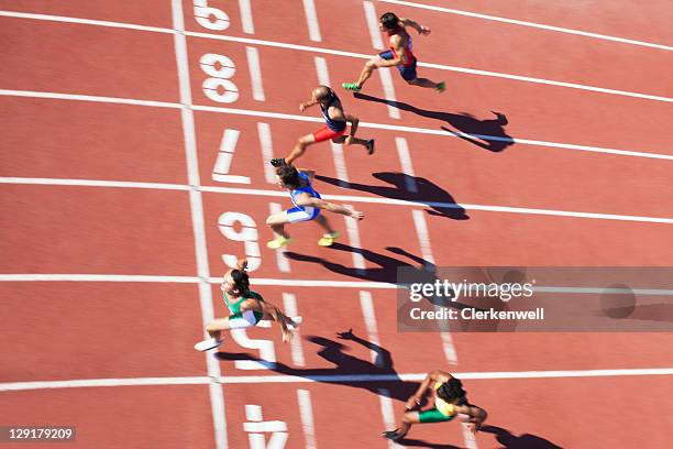 athletics runners at track and field event - mens track stock pictures, royalty-free photos & images