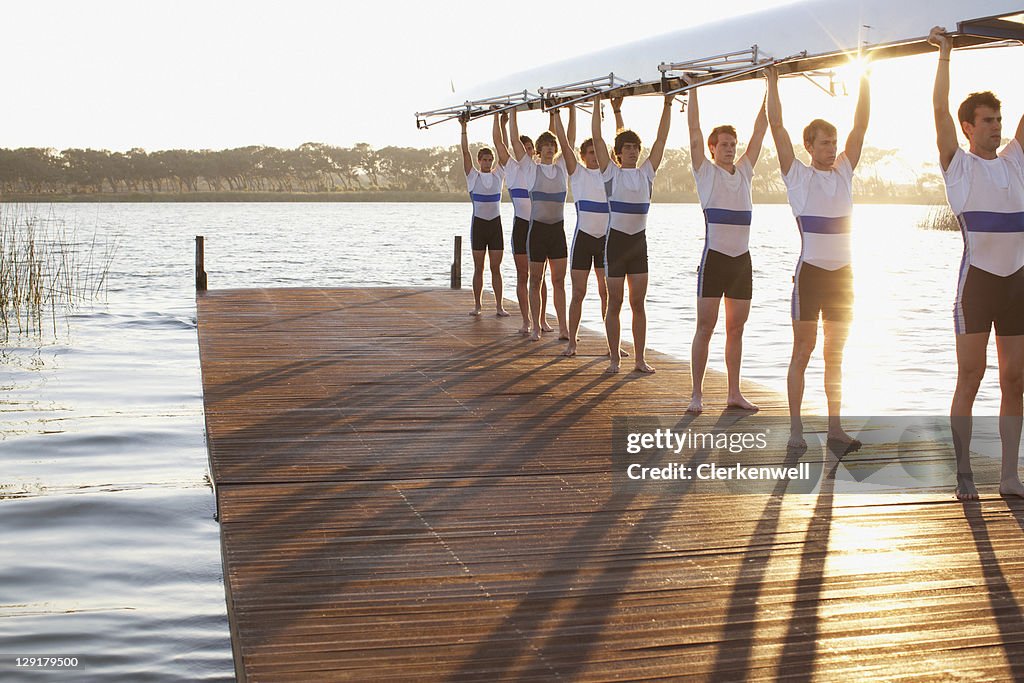 Athletes holding their boat upwards