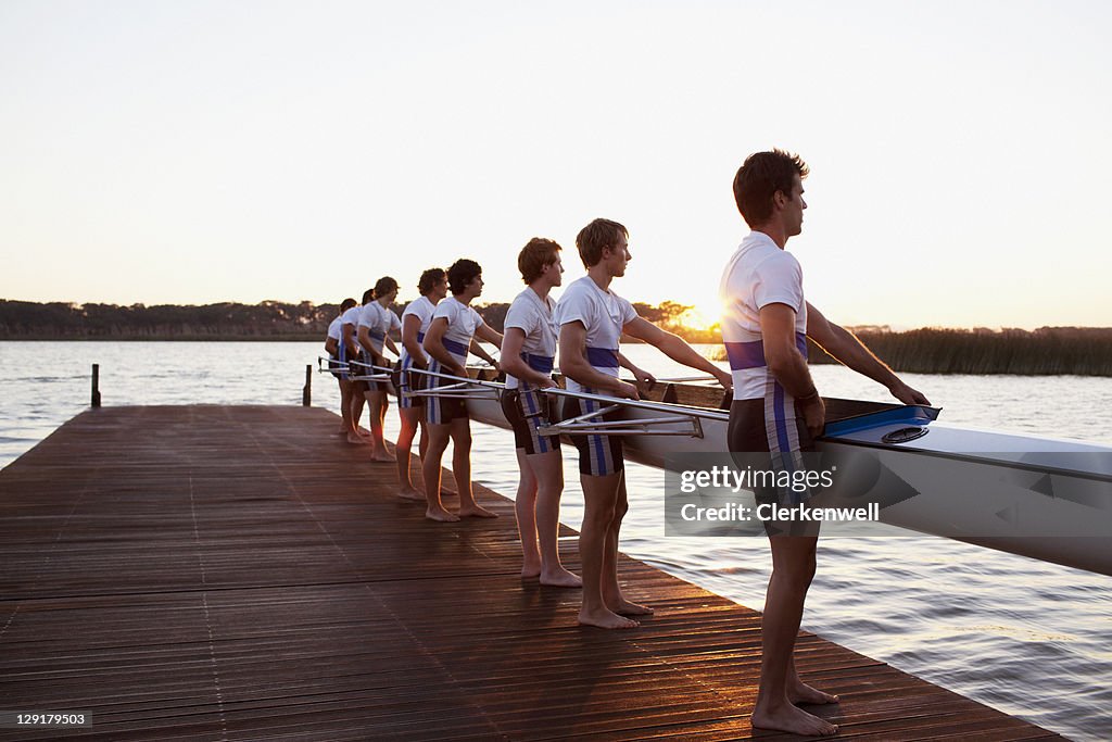 Side view of men holding boat