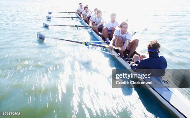 men in row boat oaring - oar stock pictures, royalty-free photos & images