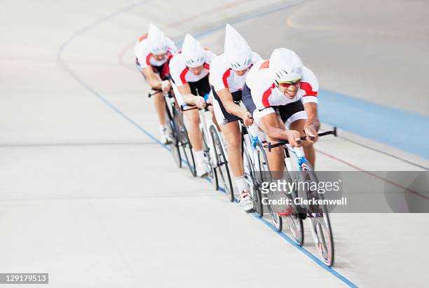 cyclists racing in sports track - baanwielrennen stockfoto's en -beelden