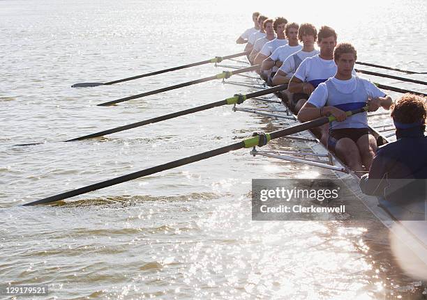 athletes in a crew canoe - rudern stock pictures, royalty-free photos & images