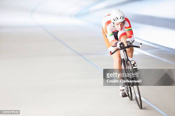 male cyclist riding bike - pursuit stock pictures, royalty-free photos & images