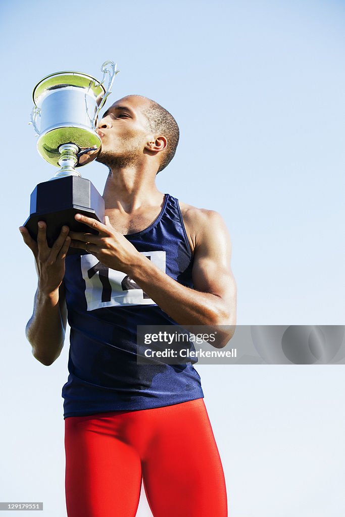 Winner kissing his trophy