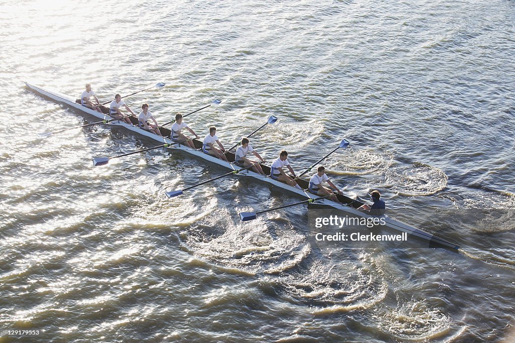 People in long canoe oaring