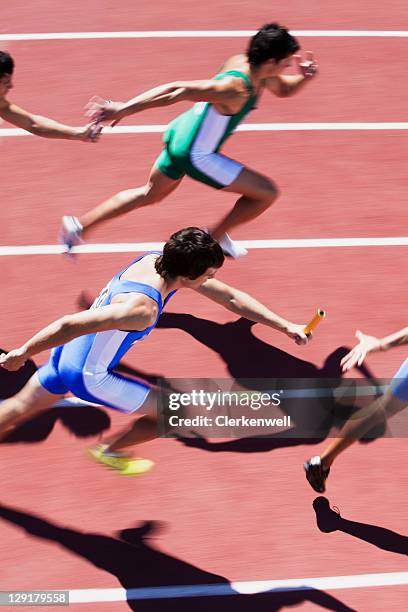 high angle view of men passing relay baton - estafette stockfoto's en -beelden