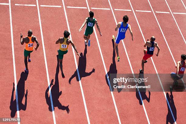male runners competing on track - mens track stock pictures, royalty-free photos & images