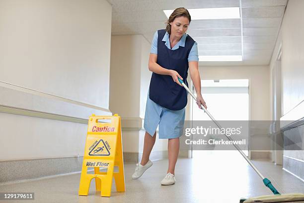 full length of woman cleaning hospital floor - hospital cleaning stock pictures, royalty-free photos & images