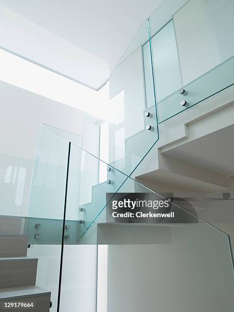 low angle view of staircase with glass railing - railing stock pictures, royalty-free photos & images