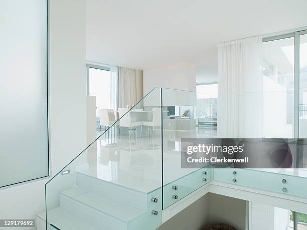 staircase with glass railing in luxurious apartment - railing stockfoto's en -beelden