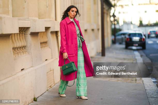 Gabriella Berdugo wears a pink fuchsia long wool coat with shoulder pads, pearl buttons, and preppy details from Stefania Viadani, green checked...