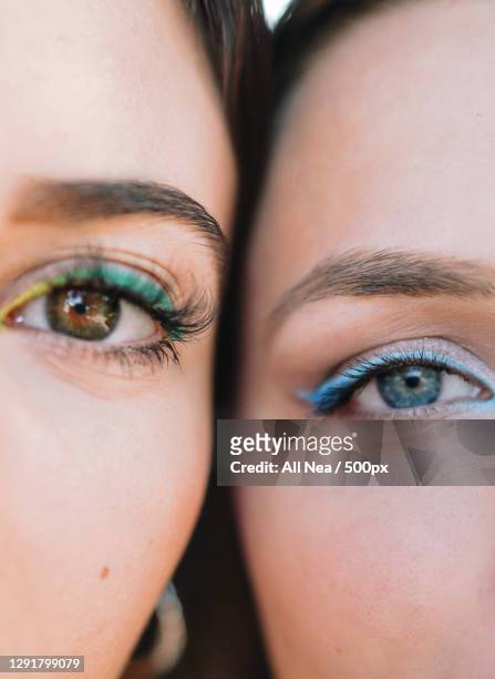 close up portrait of two caucasian women with colourful eyemakeup,spain - eyeshadow foto e immagini stock